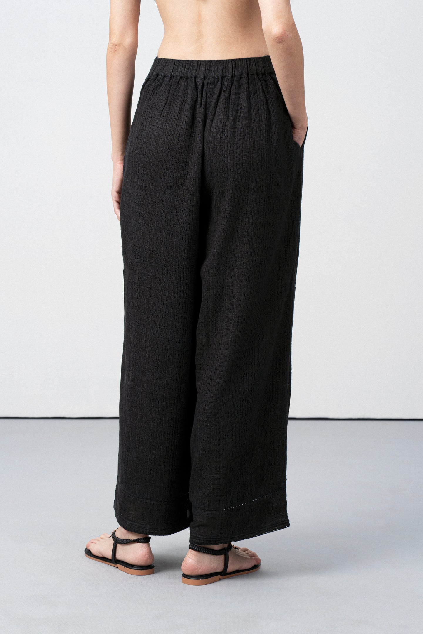 Women Pants 100% Cotton Textured Elastic Waistband Straight Fit Black Color Trousers  | Black Cotton Straight-fit Trousers For Women | Back Side View Cotton Guipure Straight Fit Trousers