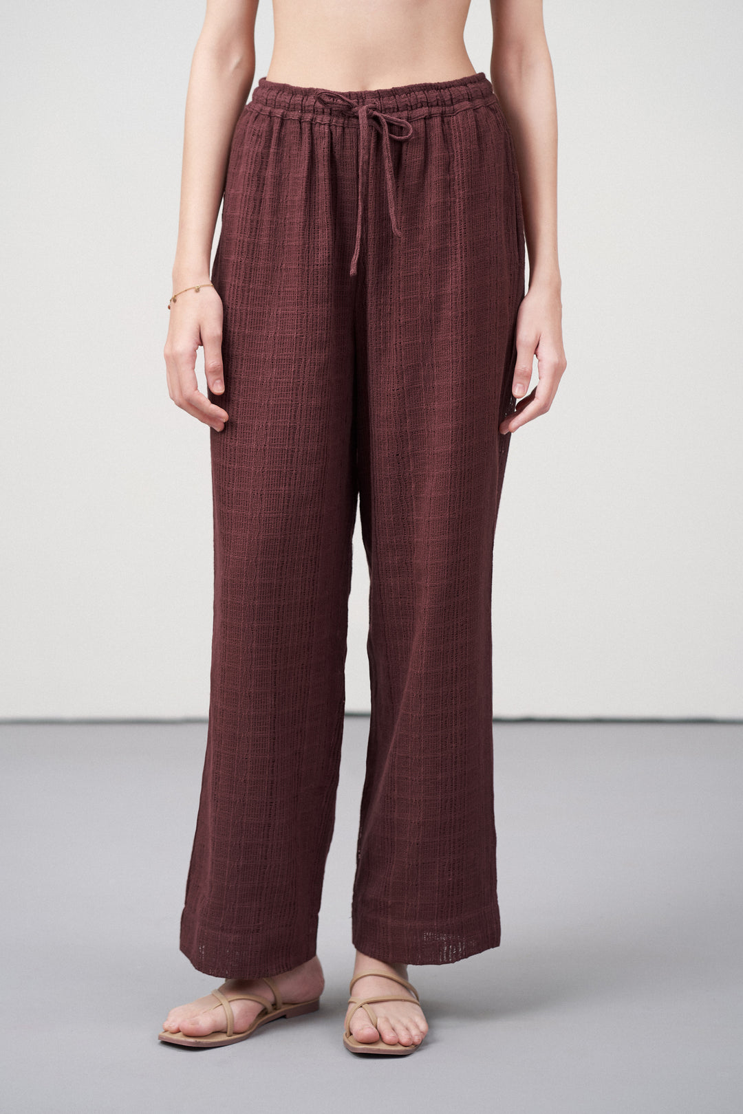 Women Pants Cotton Guipure Textured Straight Fit Elastic Waistband Maroon Trousers Front View |  Deep Rosewood Cotton Straight-fit Trousers For Women | Cotton Guipure Elasticated Waist Trousers