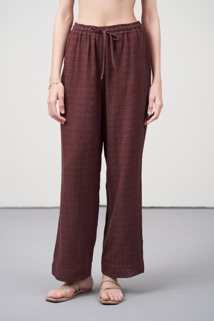 Women Pants Cotton Guipure Textured Straight Fit Elastic Waistband Maroon Trousers Front View |  Deep Rosewood Cotton Straight-fit Trousers For Women | Cotton Guipure Elasticated Waist Trousers