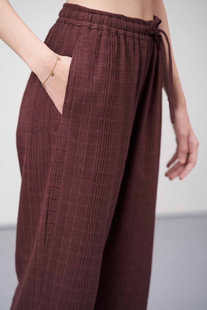 Women Pants Cotton Guipure Textured Straight Fit Elastic Waistband Maroon Trousers Right Size Closeup View | Deep Rosewood Cotton Straight-fit Trousers For Women | Cotton Guipure Elasticated Waist Trousers