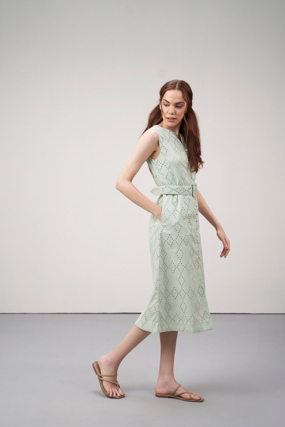 Cotton Embroidered Eyelet Split Neck Sleeveless Fabric Belt Dress For Women Ladies Light Green Color Model Side View | Women's Light Green Cotton Sleeveless Relaxed Fit Eyelet Cutwork Dress