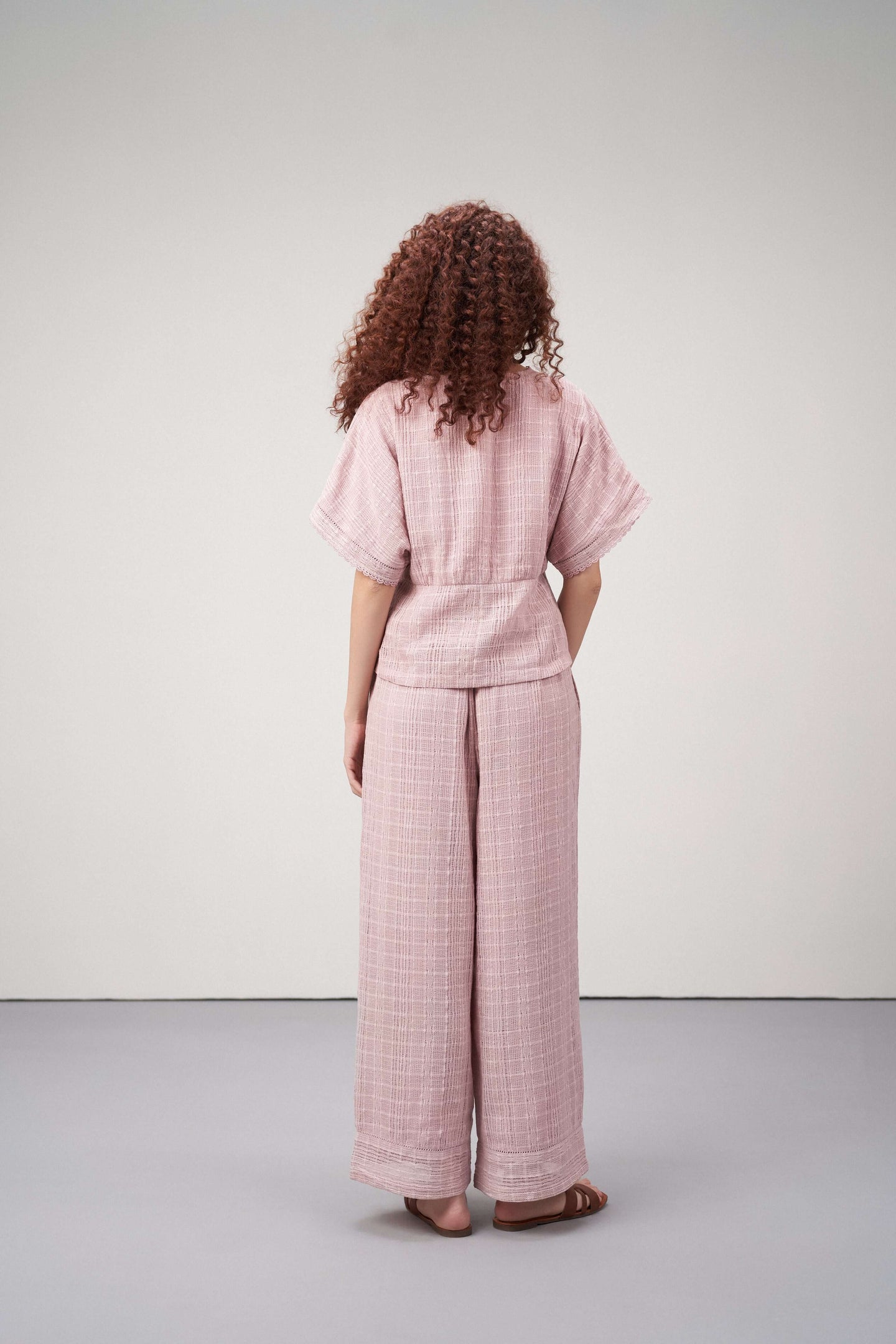 Women Pants 100% Cotton Textured Elastic Waistband Straight Fit Pink Color Trousers  | Pink Cotton Straight-fit Trousers For Women | Back Side View Cotton Guipure Straight Fit Trousers