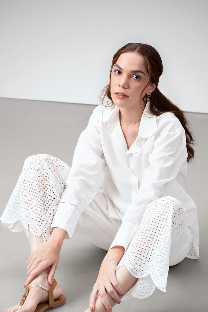 women pants white embroidery eyelet cutwork high rise scallop white trousers model sitting view