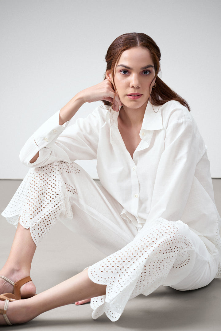 women pants white embroidery eyelet cutwork high rise scallop white trousers model sitting photo