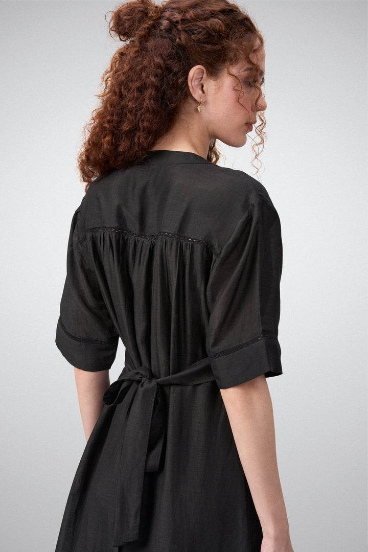 Linen Half Sleeves Adjustable Side Tie Belt Button Front Short Dress For Women Ladies Black Color Model Side View | Black Linen Blend Relaxed Fit Dress With Mandarin Collar