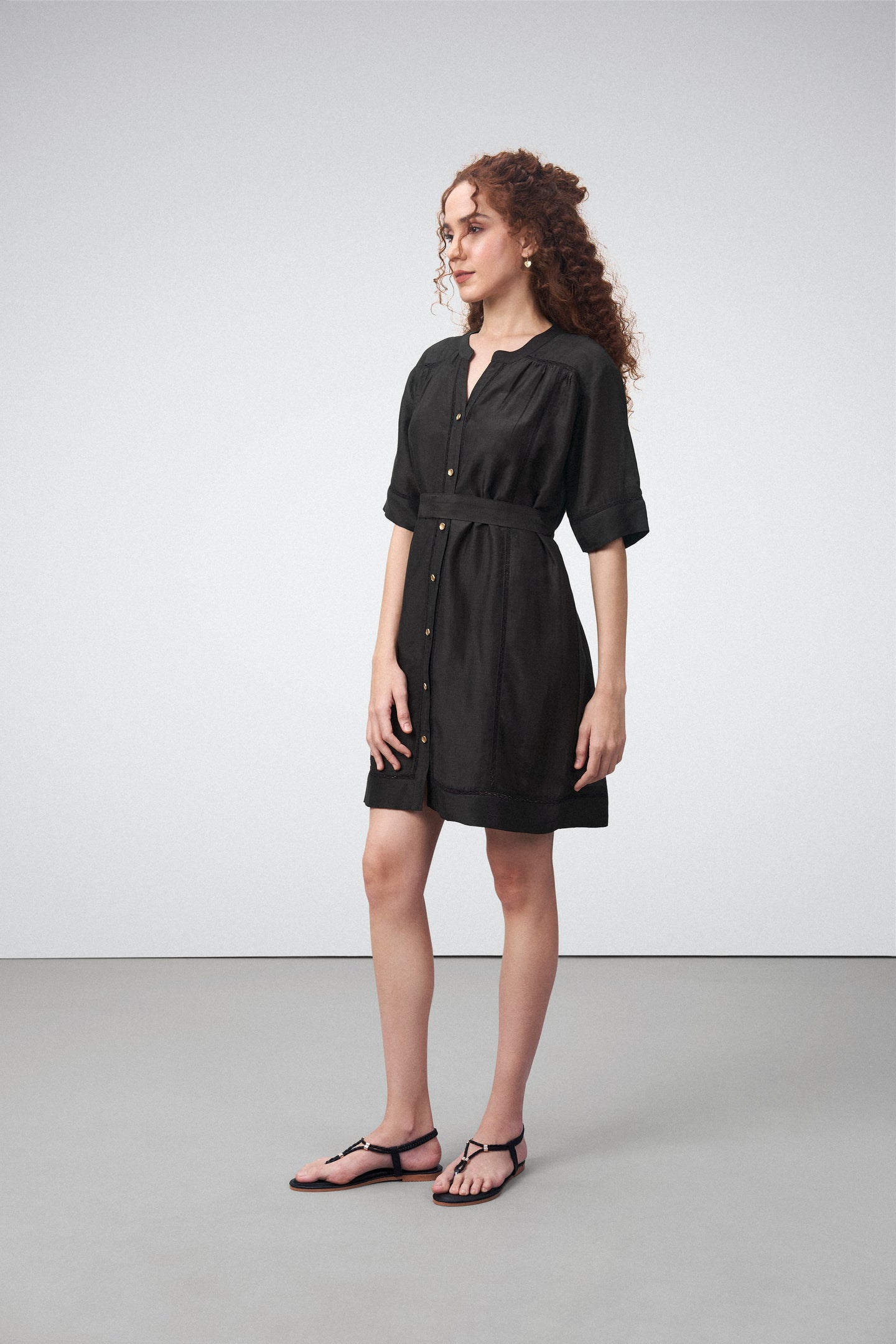 Linen Half Sleeves Adjustable Side Tie Belt Button Front Short Dress For Women Ladies Black Color Model Side View | Black Linen Blend Relaxed Fit Dress With Mandarin Collar