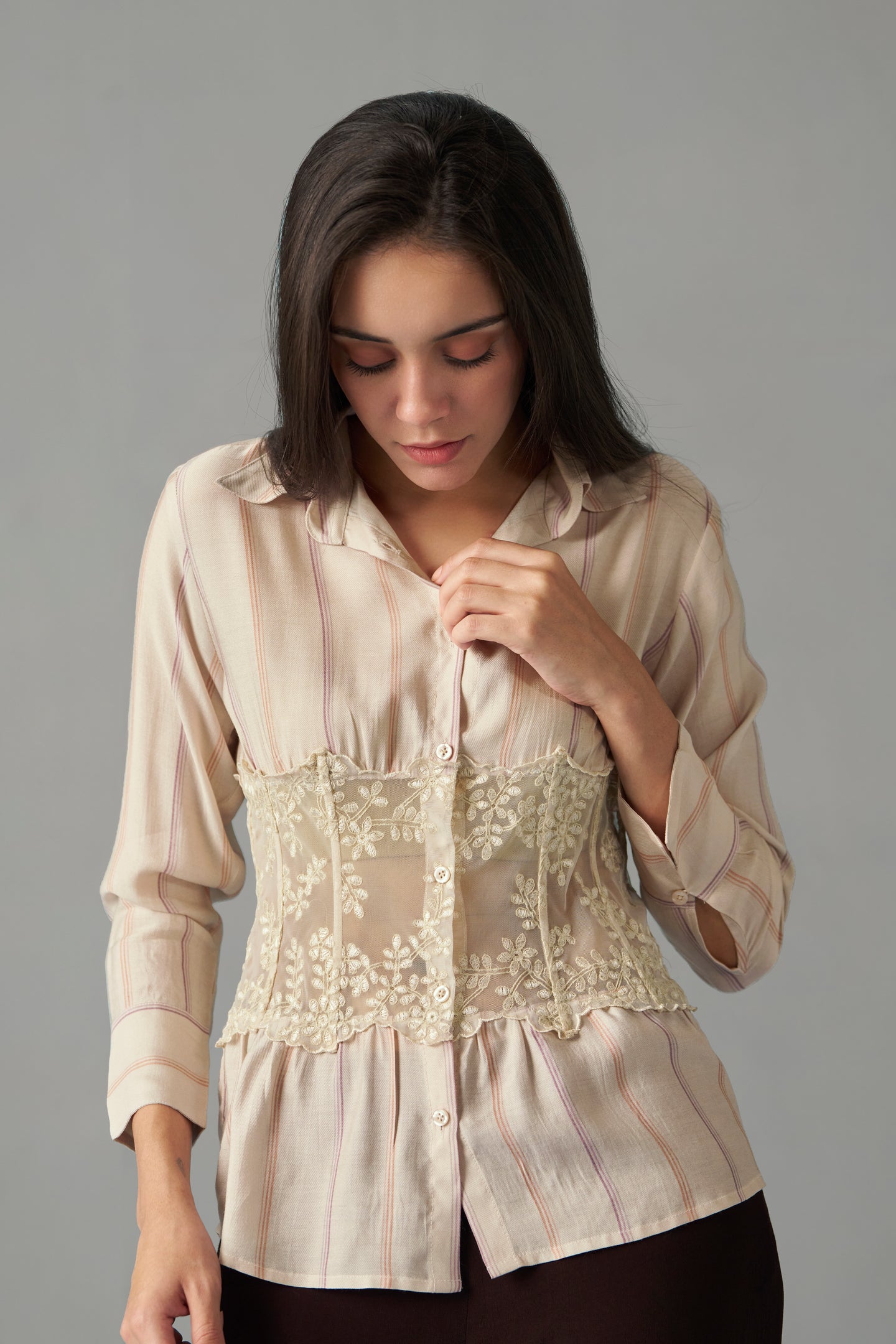 Embroidered Corset Detail Shirt for Women in Stripe Print by House of Sava . Woman wearing a beige blouse with lace details on a gray background