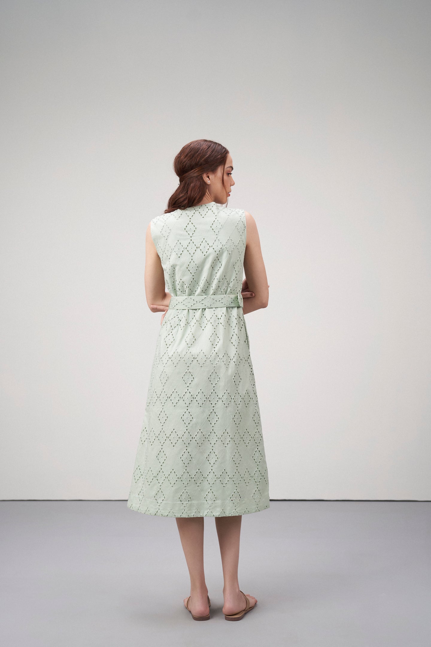 Cotton Embroidered Eyelet Split Neck Sleeveless Fabric Belt Dress For Women Ladies Light Green Color Model Back View | Women's Light Green Cotton Sleeveless Relaxed Fit Eyelet Cutwork Dress

