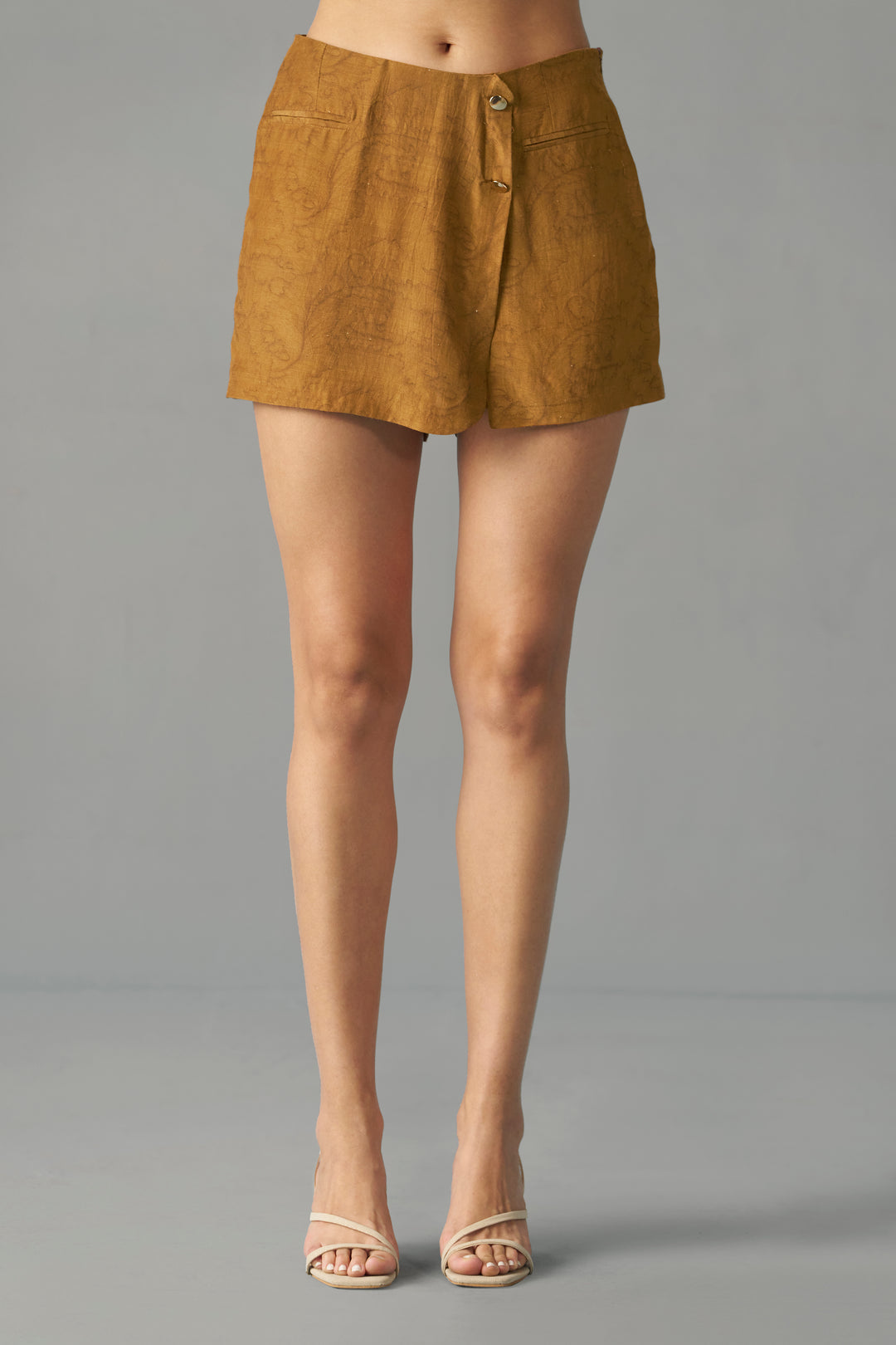 Mustard Printed Wrap Skorts for Women by House of Sava, Person wearing a mustard yellow skirt on a gray background