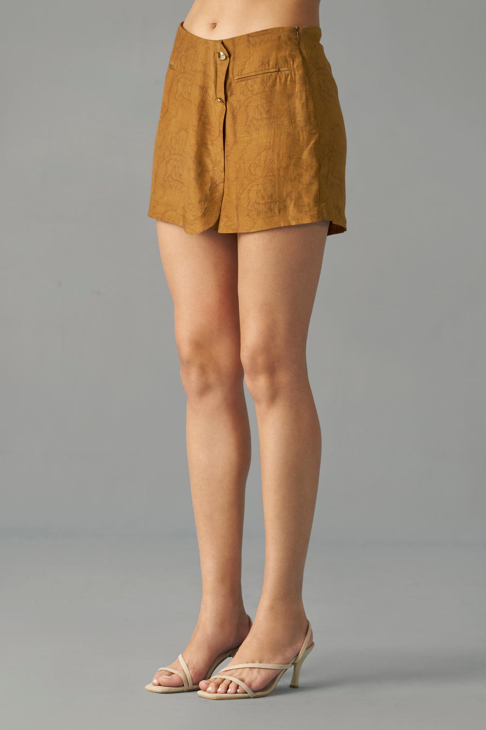 Mustard Printed Wrap Skorts for Women Side Profile View. Person wearing a mustard yellow skirt on a gray background
