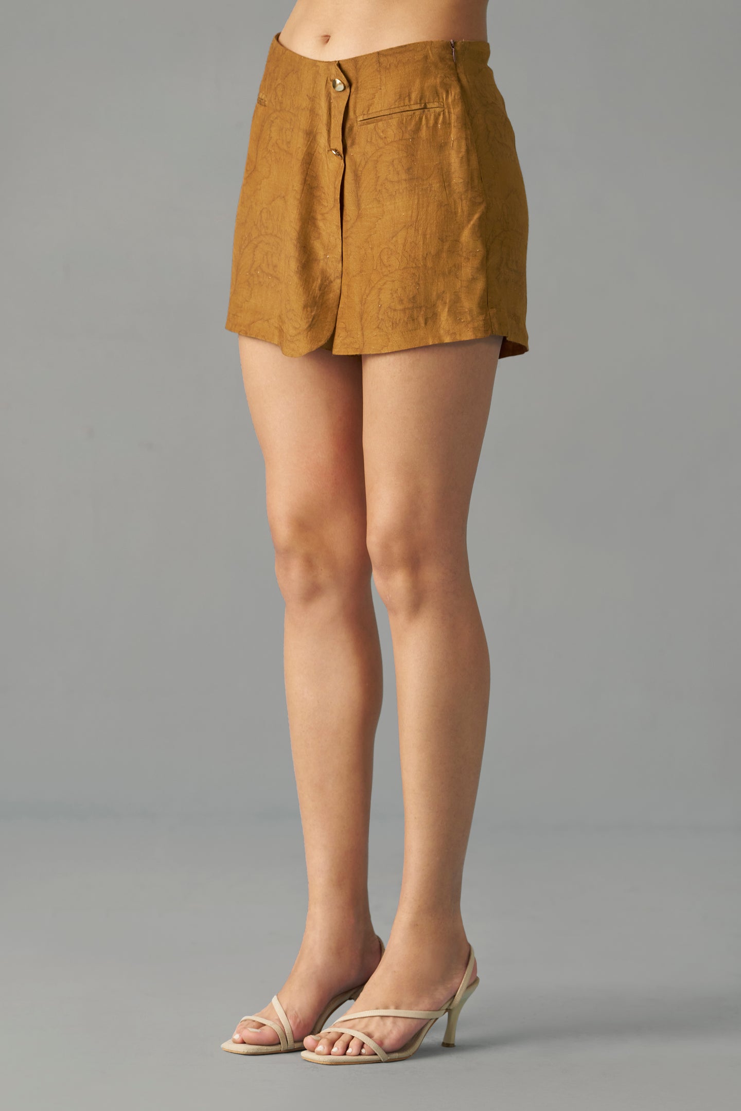 Mustard Printed Wrap Skorts for Women Side Profile View. Person wearing a mustard yellow skirt on a gray background