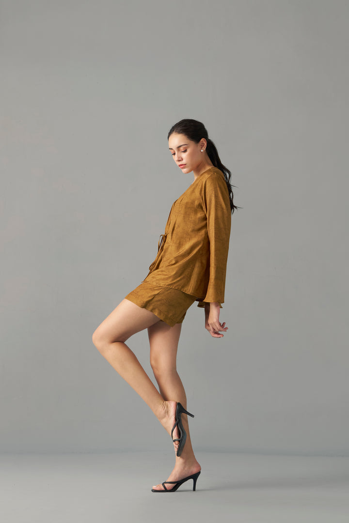 rendy Mustard Printed Skorts with Wrap Front Detail , Woman in a mustard yellow dress standing against a gray background