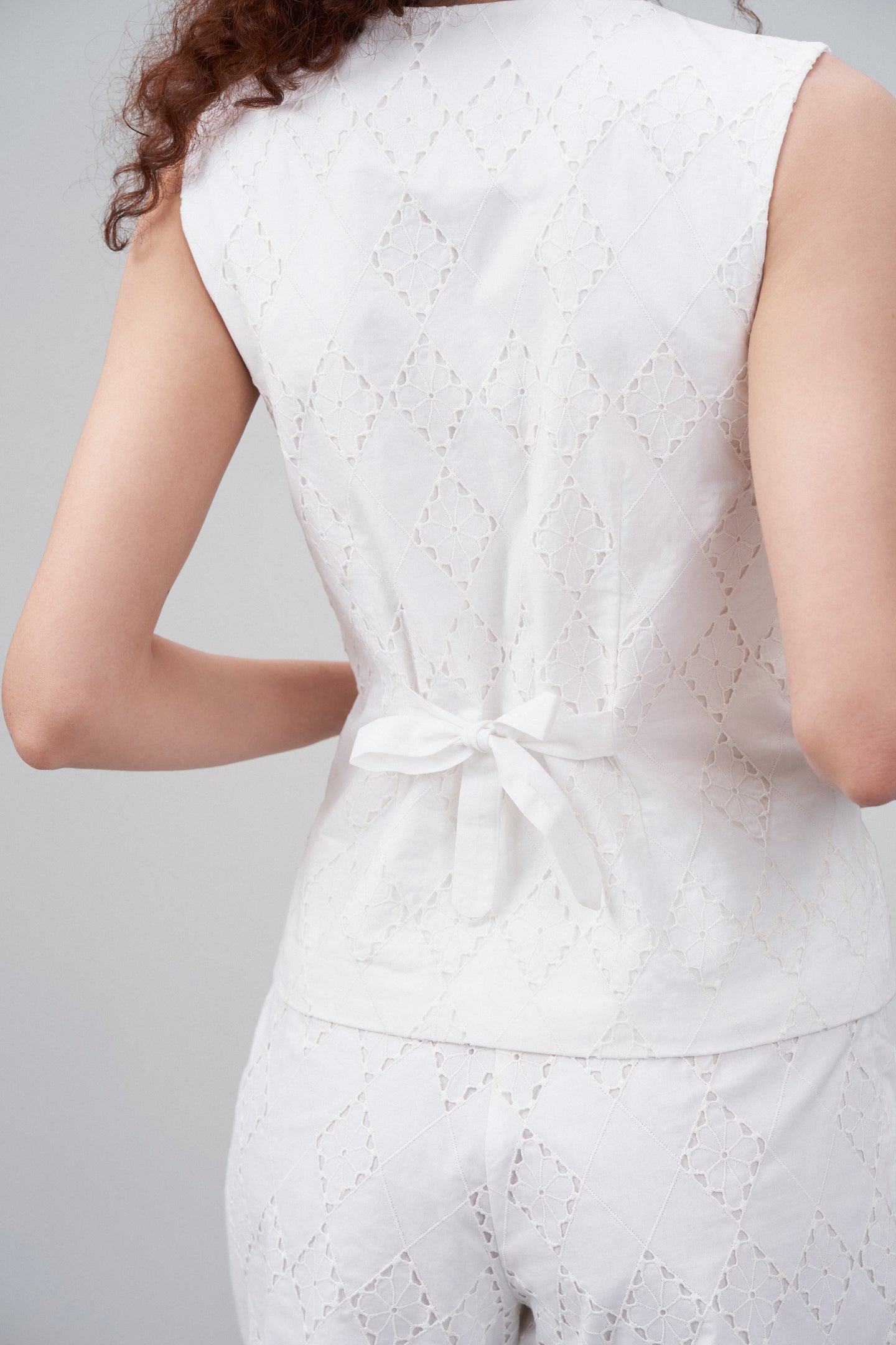 White Cotton Eyelet Embroidered Waistcoat For Women | Eyelet Embroidery Waistcoat for Back Model View
