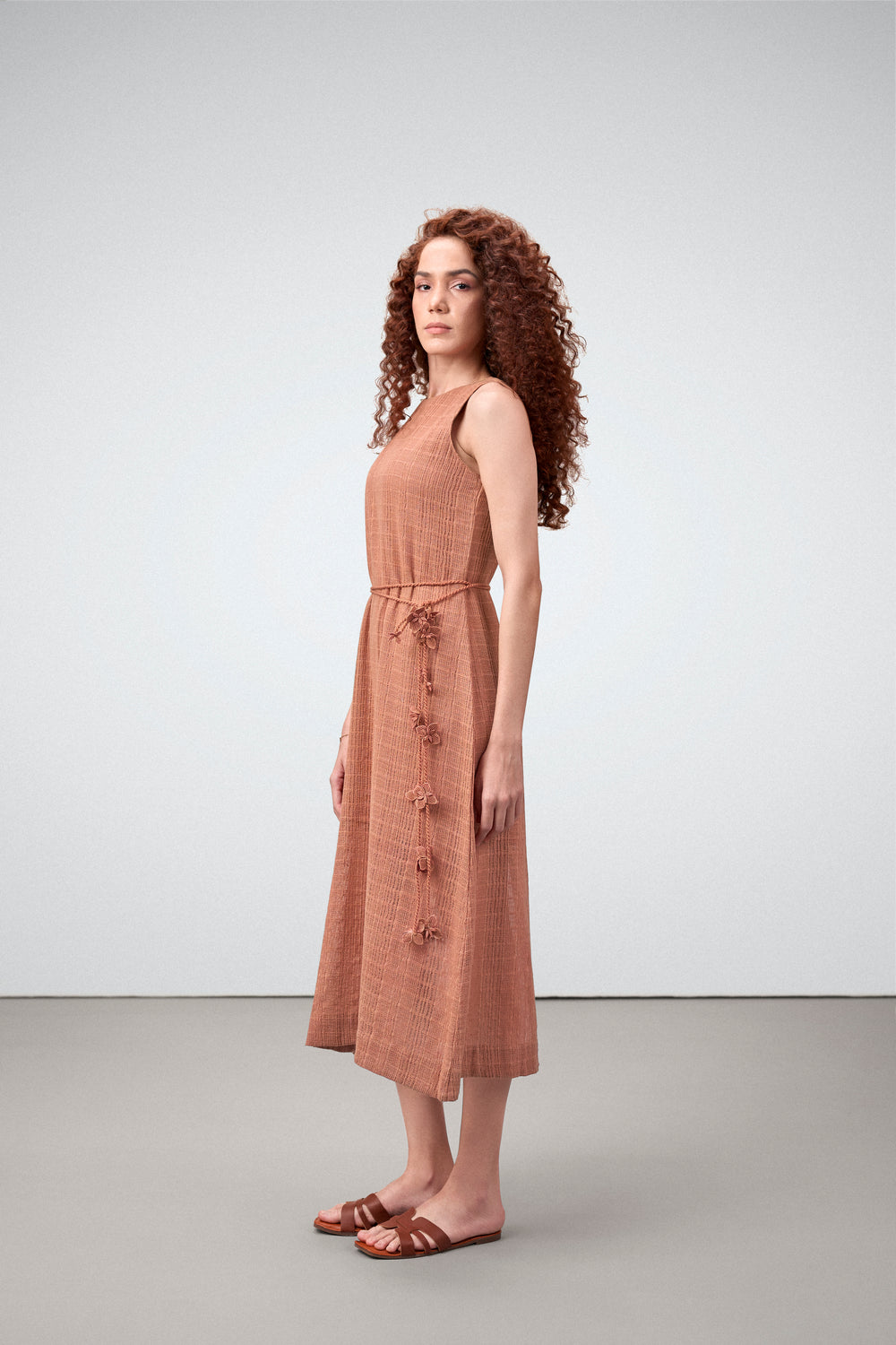 Cotton Guipure Sleeveless Round Neckline Floral Accents Bloom Midi Dress For Women Ladies Terracotta Color Model Side View | Terracotta Guipure Bloom Midi Dress | Cotton Midi Dress For Women
